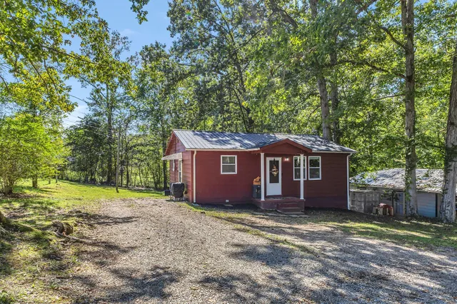 a view of a house with large trees