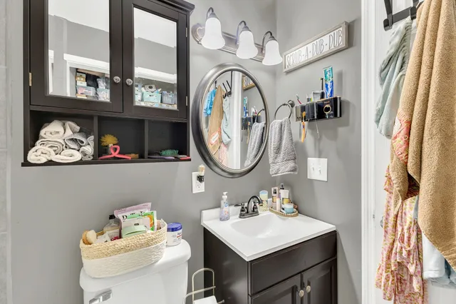 a bathroom with a sink mirror and vanity
