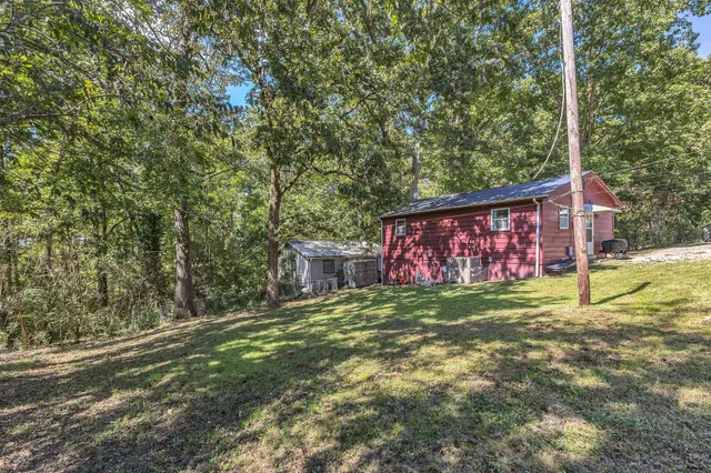 a backyard of a house with lots of green space and plants