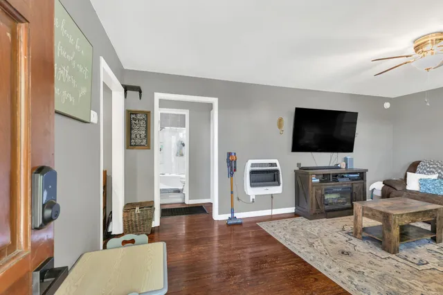 a living room with furniture a flat screen tv and a fireplace