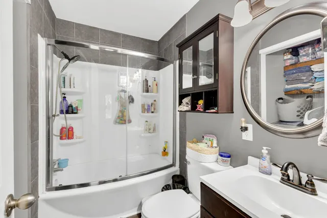 a bathroom with a sink toilet and shower