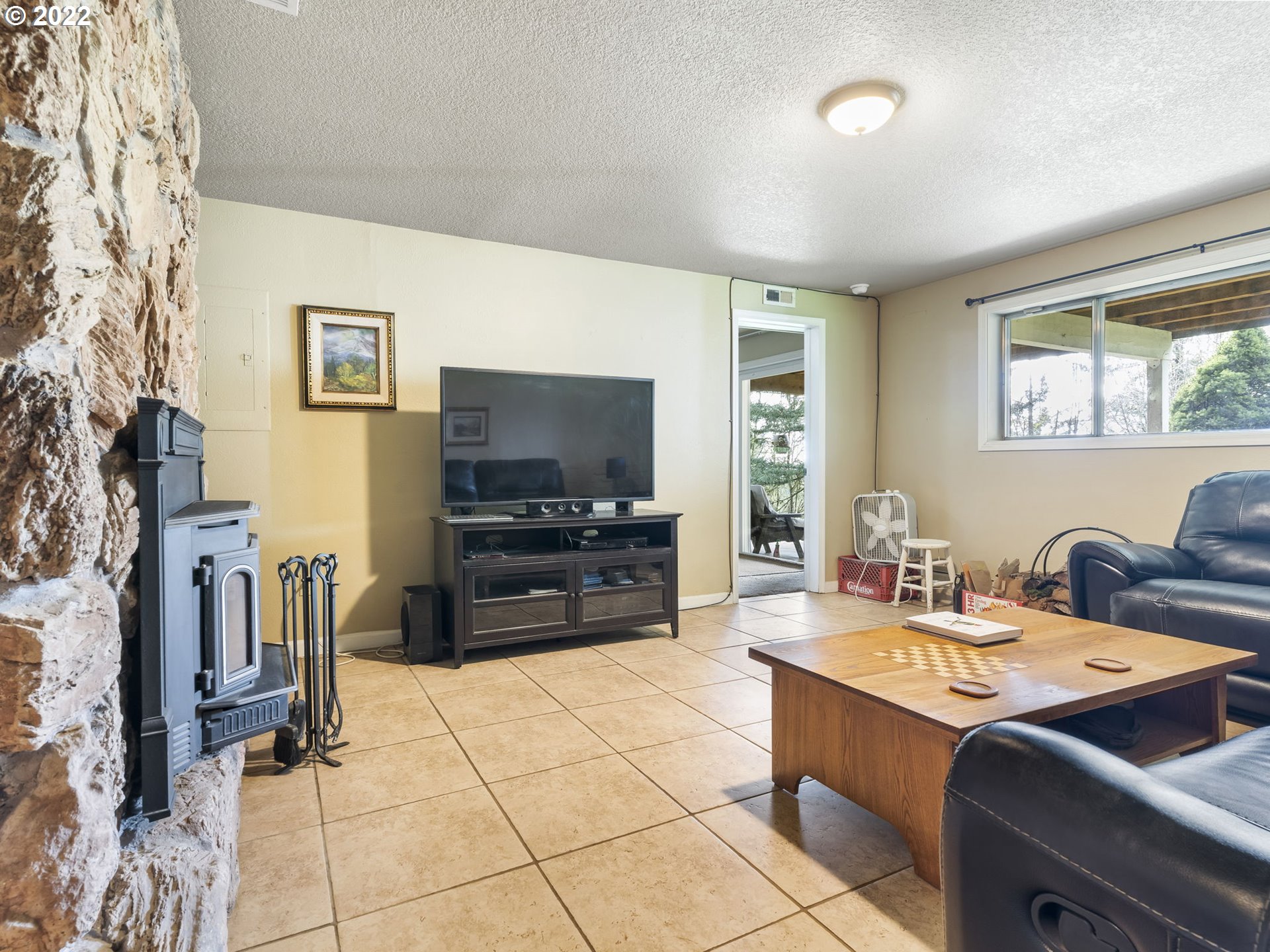 39530 Southwest Gibson Road Gaston, OR 97119 - Photo 15 of 31 a living room with furniture and a flat screen tv