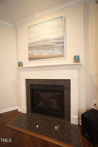 a living room with a fireplace and a table