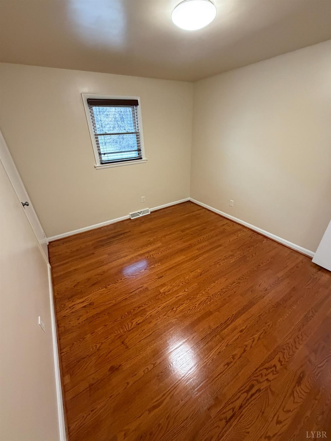 106 Bryant Road Lynchburg, VA 24502 - Photo 18 of 39 an empty room with wooden floor and window