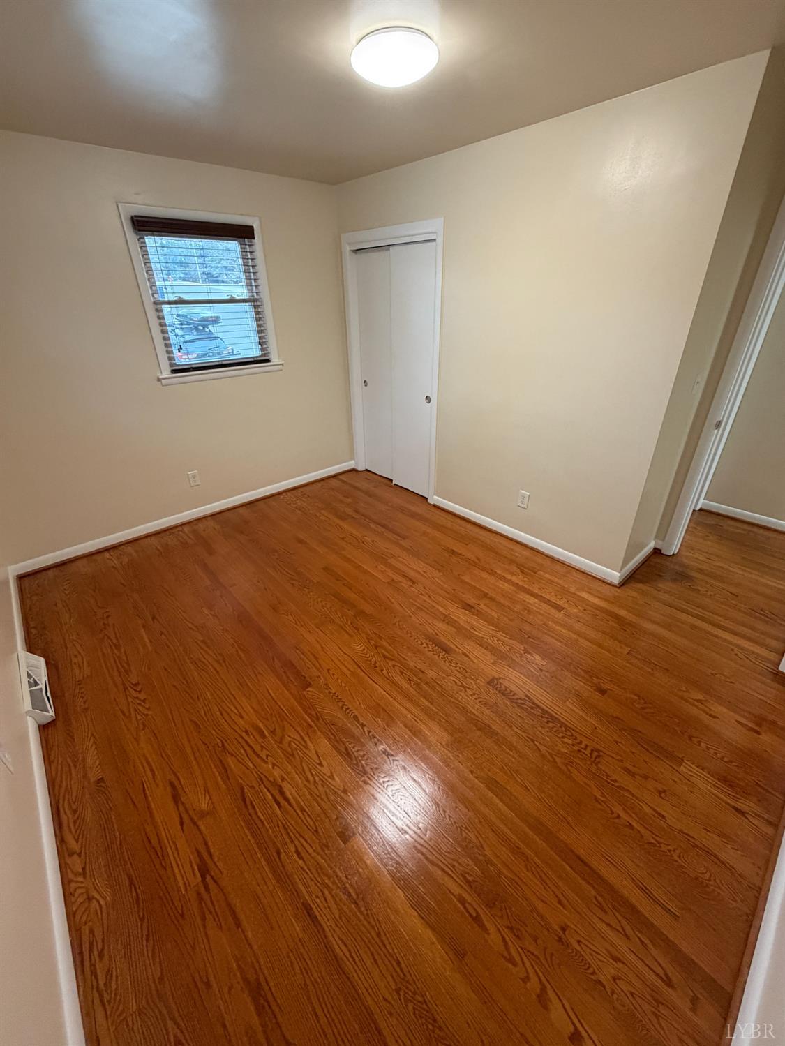 106 Bryant Road Lynchburg, VA 24502 - Photo 20 of 39 an empty room with wooden floor and windows