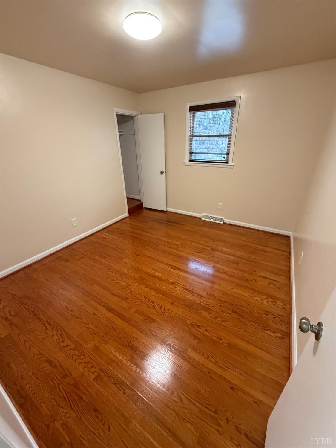 106 Bryant Road Lynchburg, VA 24502 - Photo 22 of 39 an empty room with wooden floor and windows