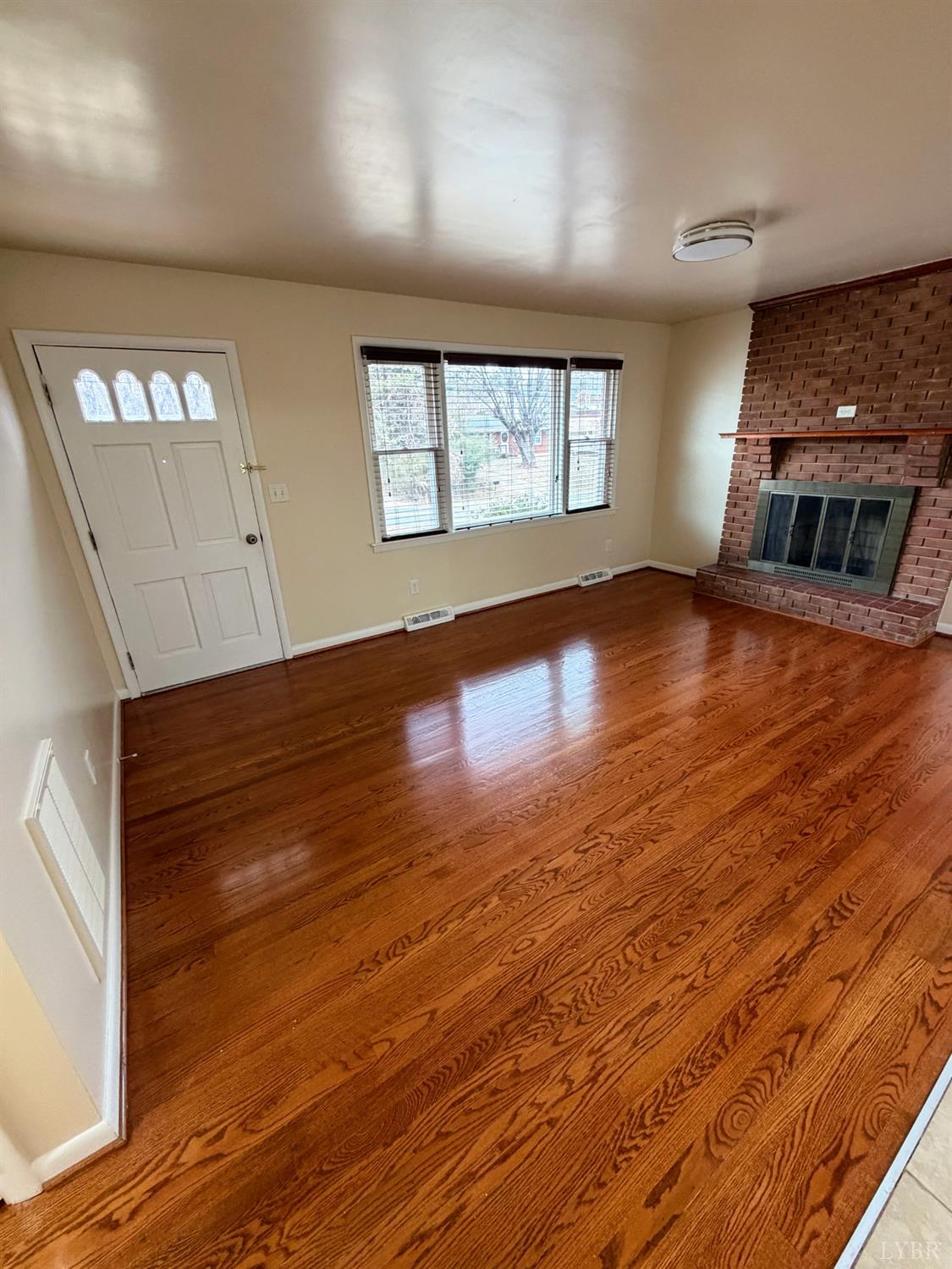 106 Bryant Road Lynchburg, VA 24502 - Photo 8 of 39 an empty room with wooden floor and windows