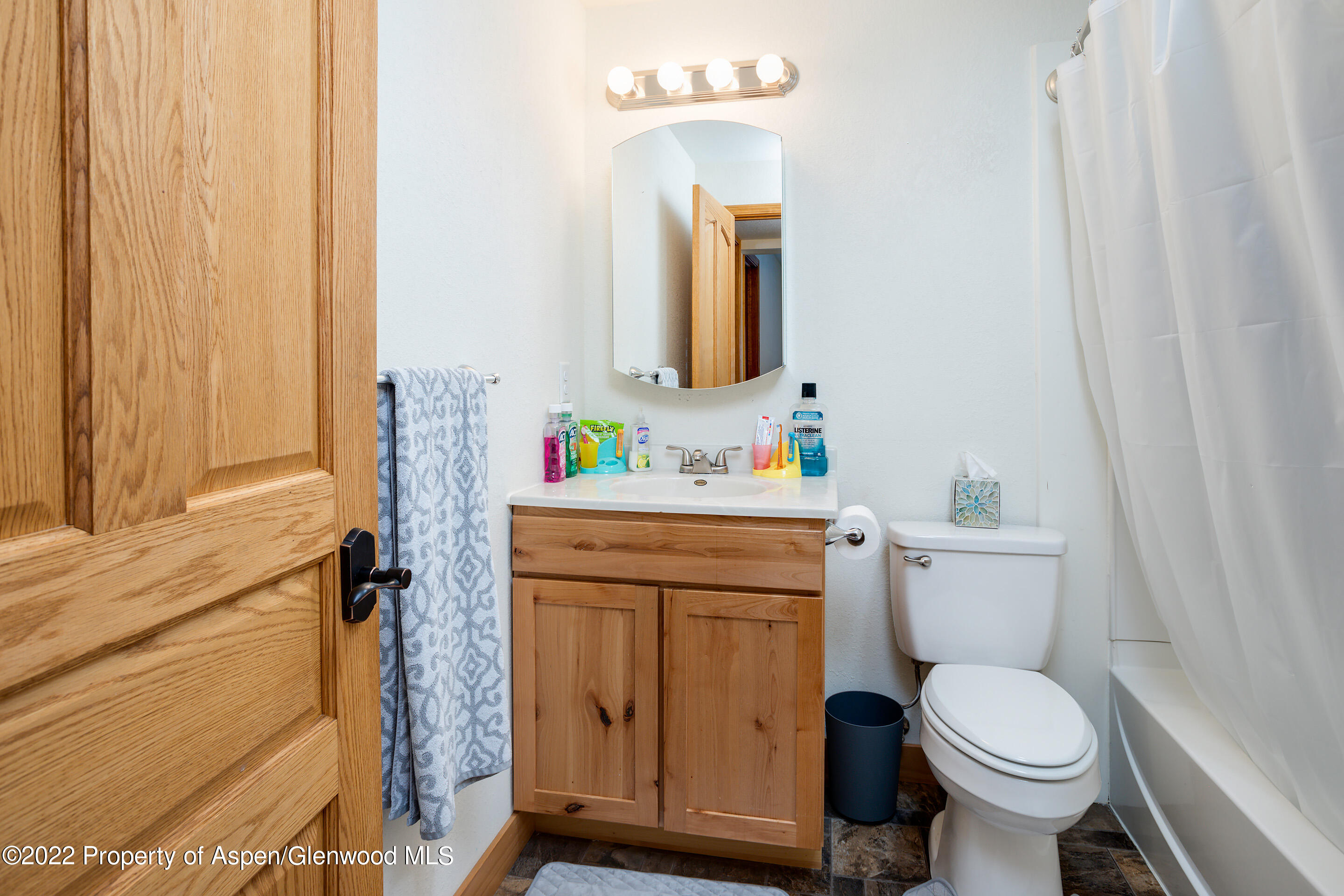 328 Little Bend Road Hayden, CO 81639 - Photo 21 of 27 a bathroom with a toilet sink vanity and mirror