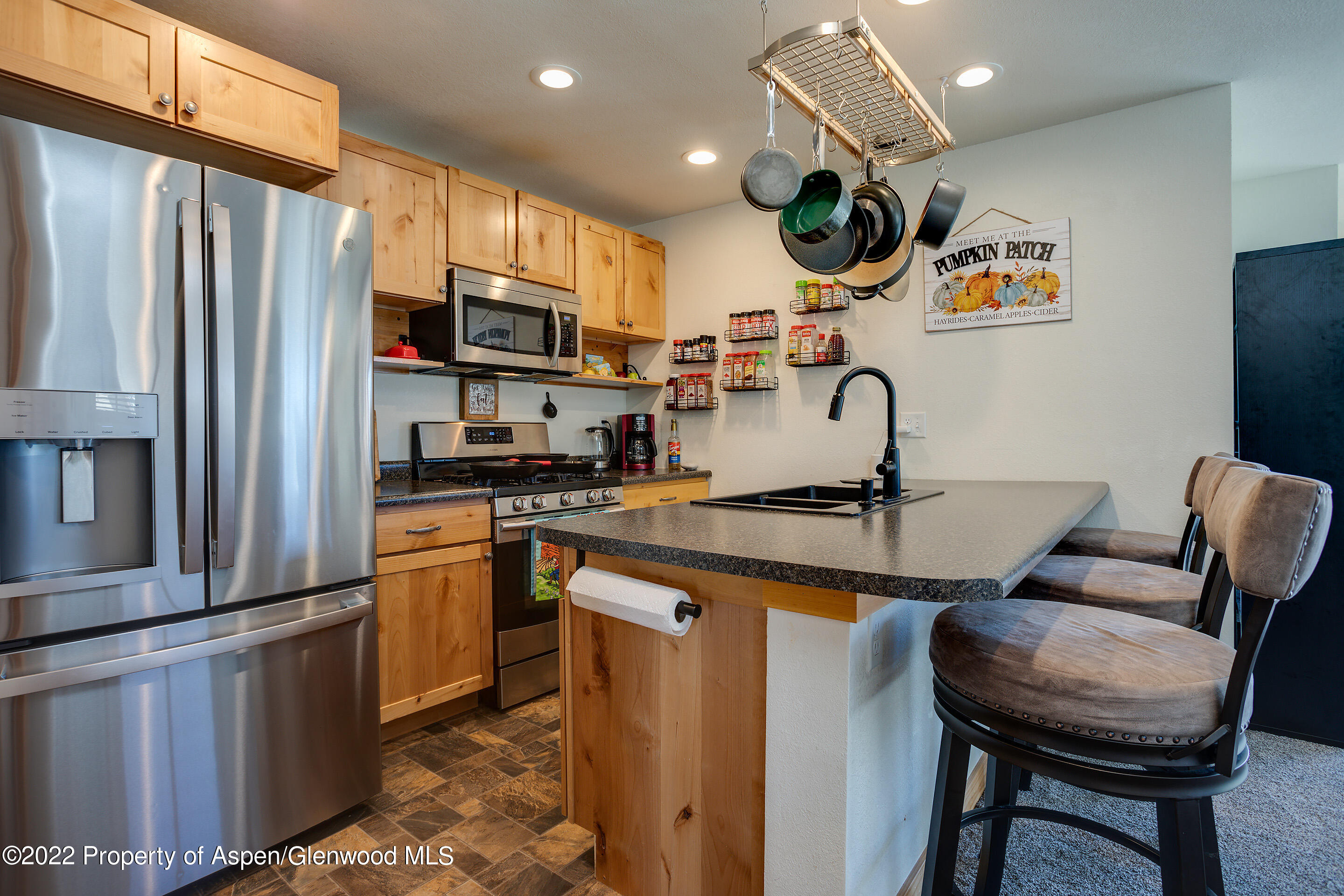 328 Little Bend Road Hayden, CO 81639 - Photo 6 of 27 a kitchen with stainless steel appliances granite countertop a sink refrigerator and cabinets