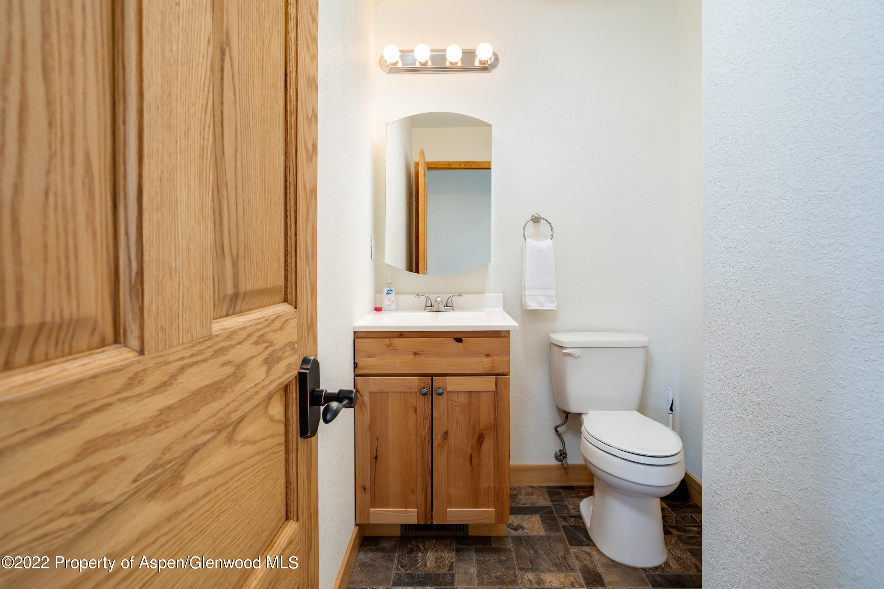 328 Little Bend Road Hayden, CO 81639 - Photo 8 of 27 a bathroom with a toilet sink and mirror