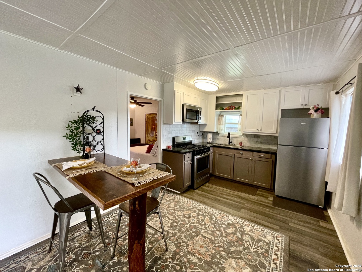 406 Hackberry Street Bandera, TX 78003 - Photo 11 of 34 a kitchen with a refrigerator and a stove top oven