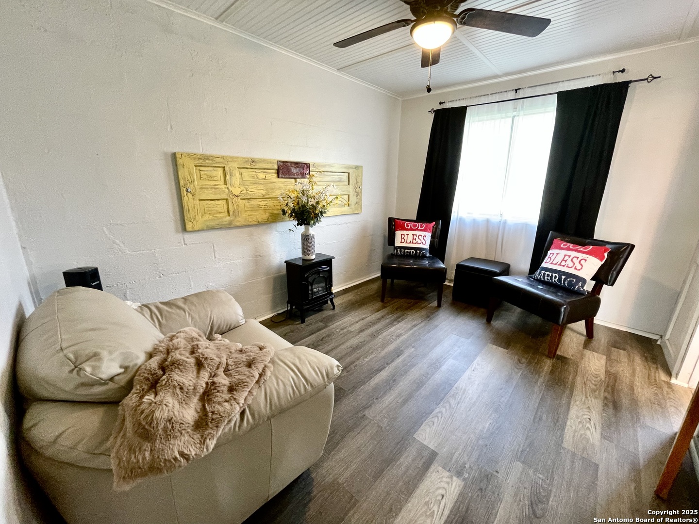 406 Hackberry Street Bandera, TX 78003 - Photo 22 of 34 a bedroom with a bed and wooden floor