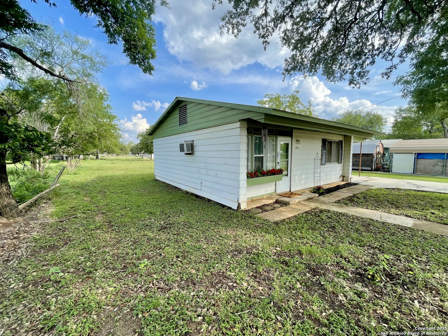 406 Hackberry Street Bandera, TX 78003 - Photo 23 of 34 a view of a house with a yard