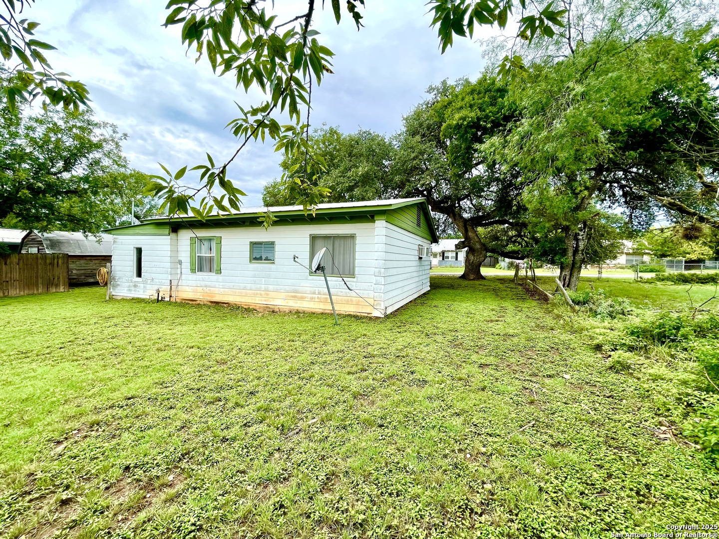 406 Hackberry Street Bandera, TX 78003 - Photo 30 of 34 a front view of house with yard and lake
