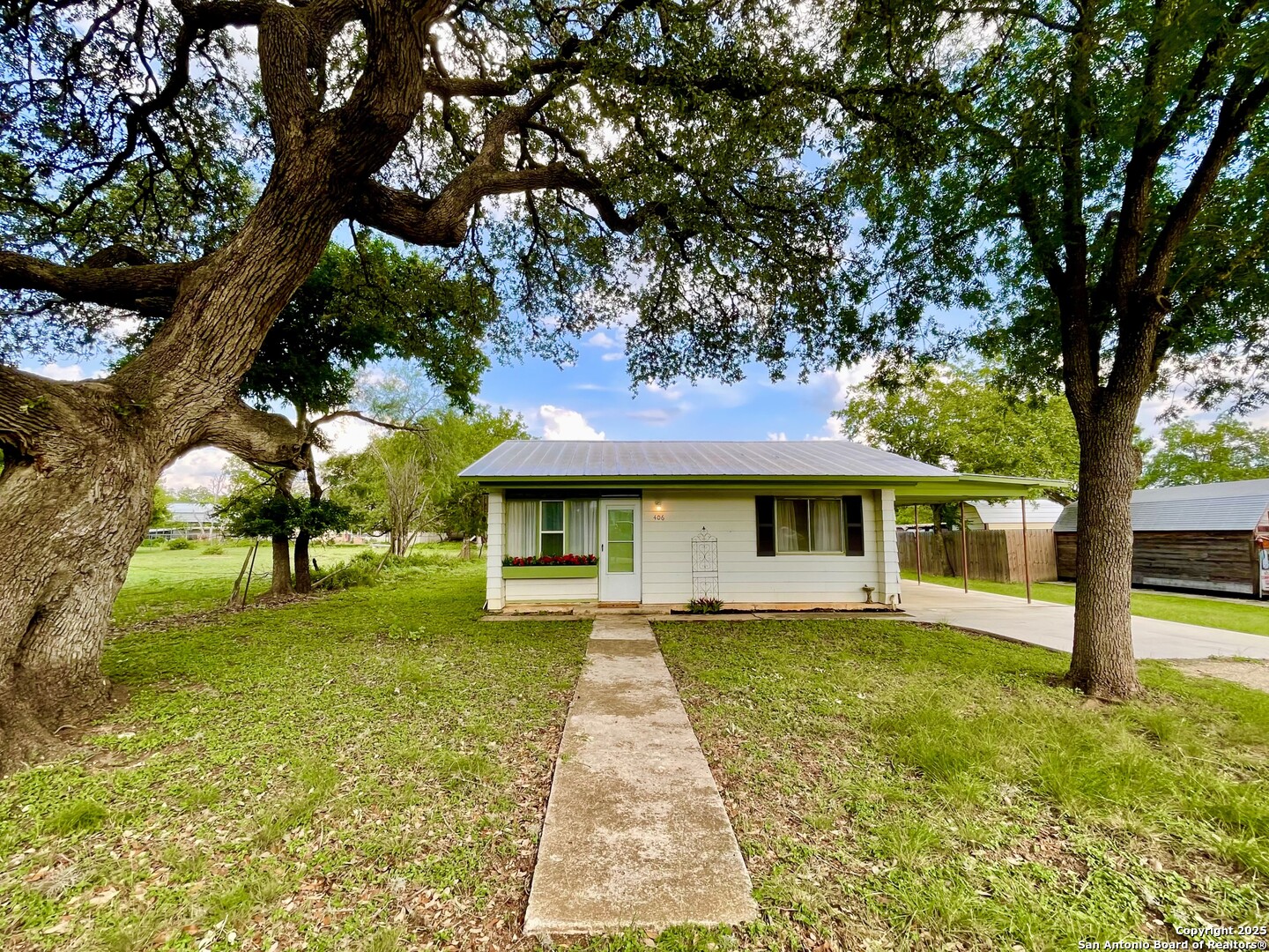 406 Hackberry Street Bandera, TX 78003 - Photo 3 of 34 a front view of house with yard and green space