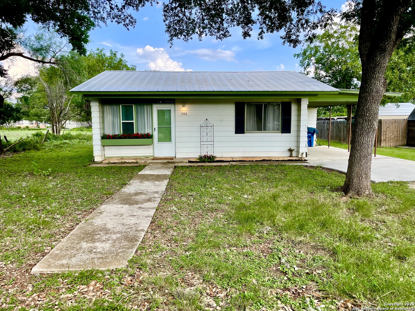 406 Hackberry Street Bandera, TX 78003 - Photo 4 of 34 a front view of a house with a yard