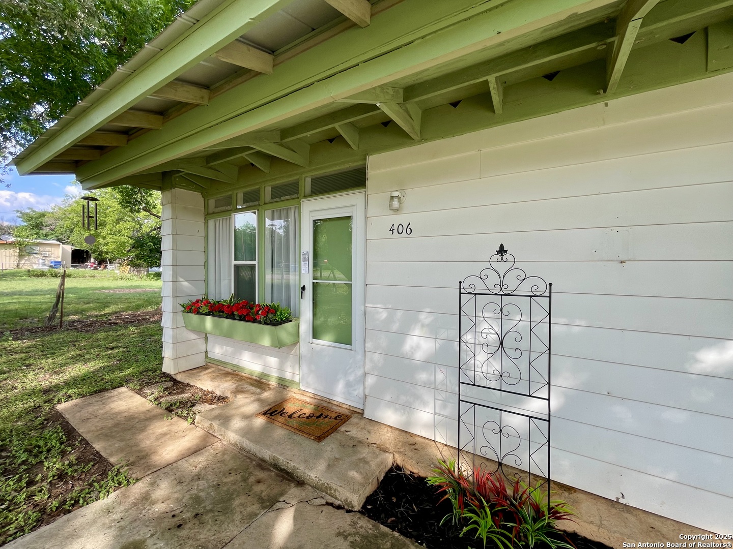 406 Hackberry Street Bandera, TX 78003 - Photo 7 of 34 a backyard of a house with seating space