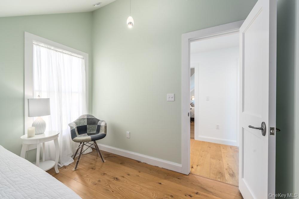 19000 Main Road Mattituck, NY 11952 - Photo 25 of 32 Bedroom with wood finished floors, lofted ceiling, and baseboards