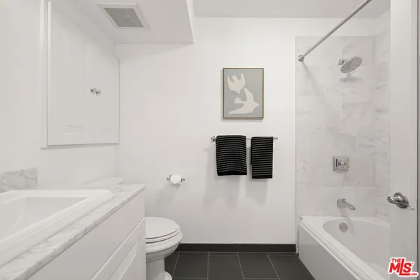 a bathroom with a sink toilet and bathtub