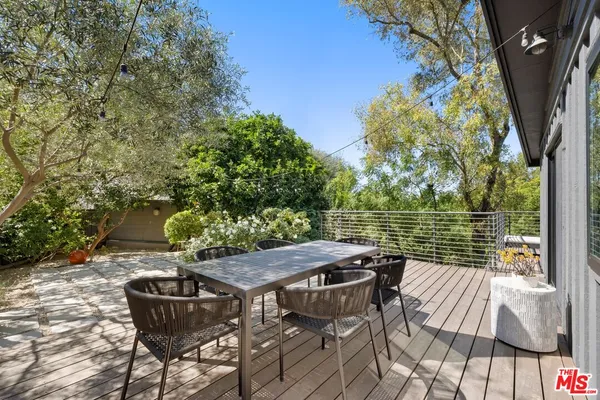 a view of a chairs and table in the patio