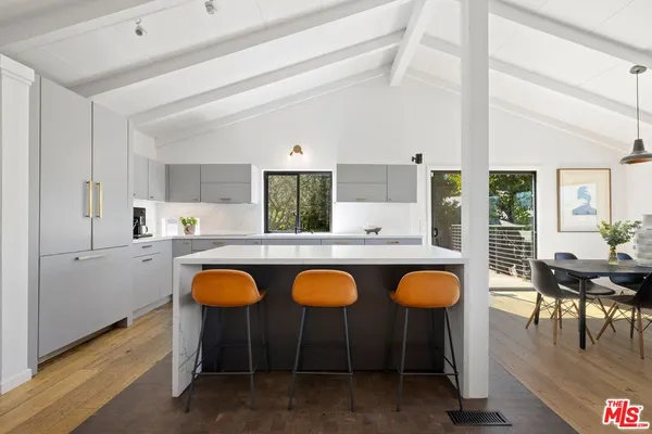 a dining room with wooden floor and furniture