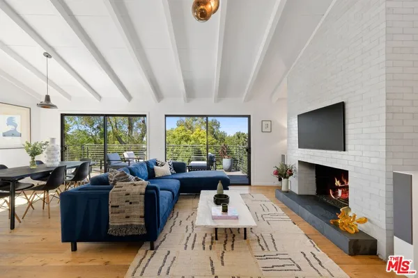 a living room with furniture fireplace and a flat screen tv