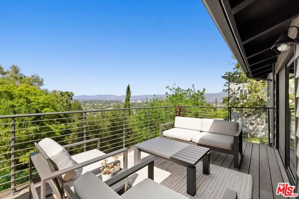 a view of a balcony with two chairs and a table
