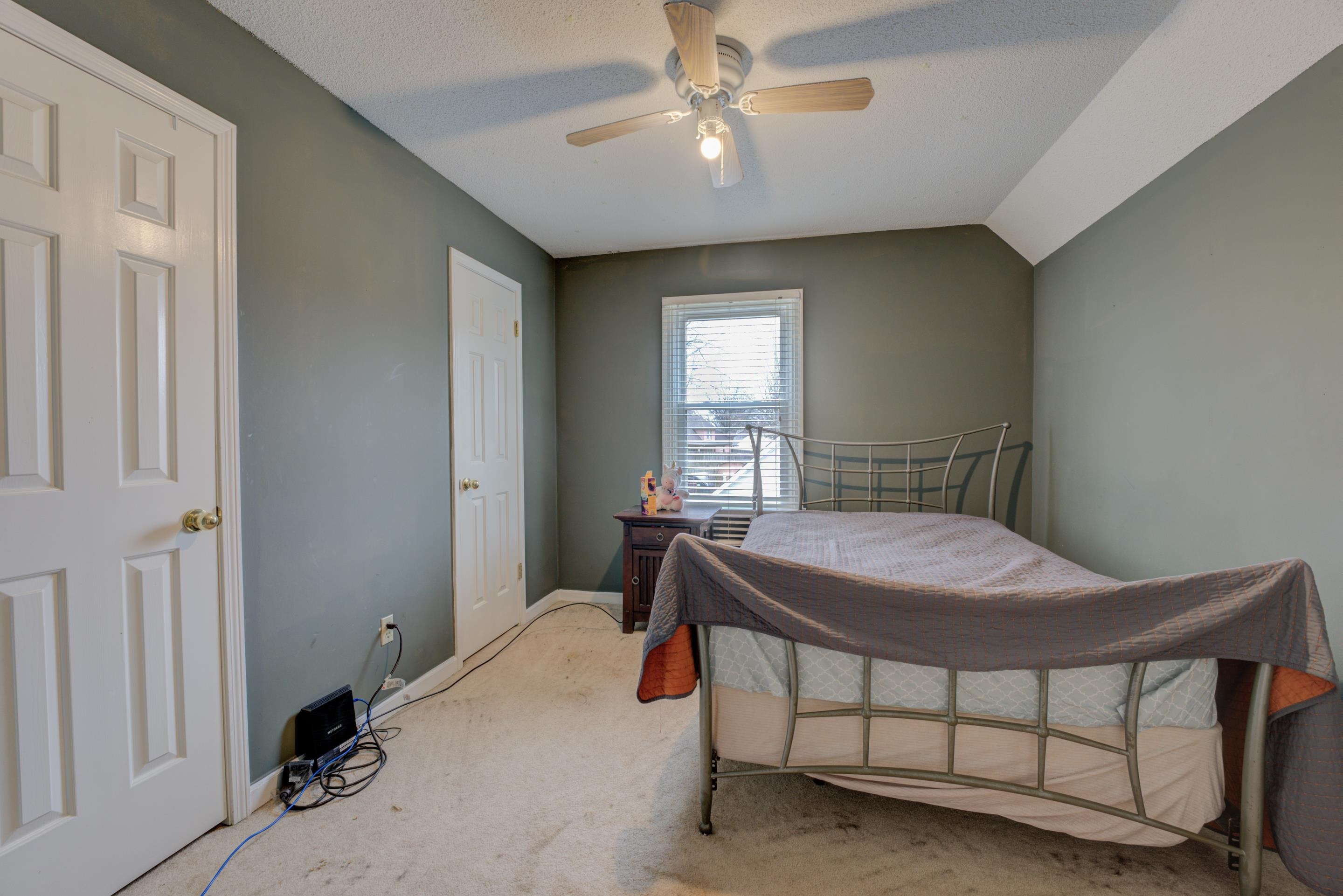 613 Silverman Drive Collierville, TN 38017 - Photo 8 of 10 a bedroom with a bed and a chandelier