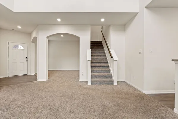 a view of a hallway with windows and stairs