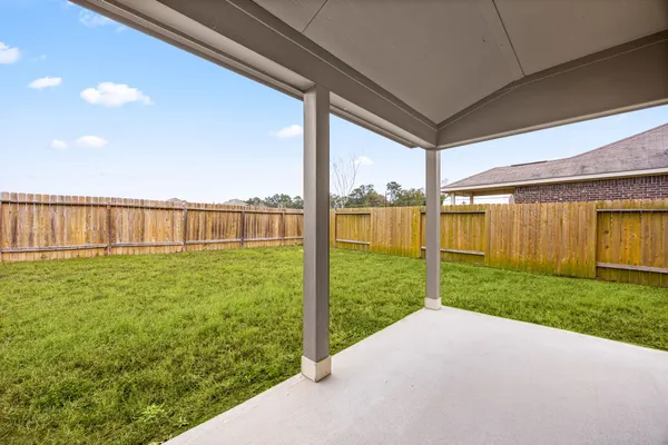 a view of a house with a yard and sitting area