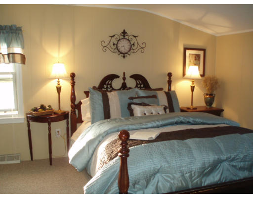 1 Emeline Road Weymouth, MA 02189 - Photo 7 of 12 a bedroom with a bed and wooden floor