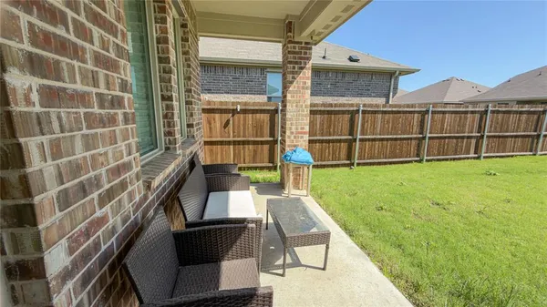 a swimming pool with outdoor seating and yard
