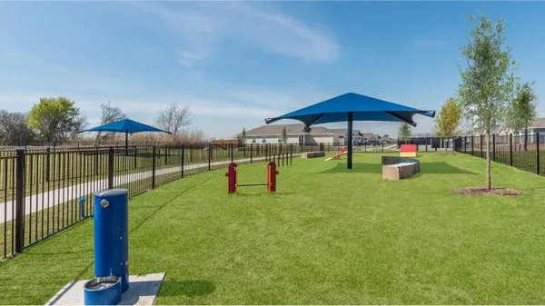 a view of a swimming pool with lawn chairs and a big yard