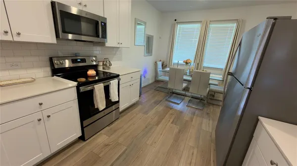 a kitchen with a sink appliances and cabinets