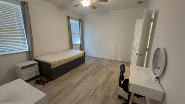 a bedroom with a bed and a chair