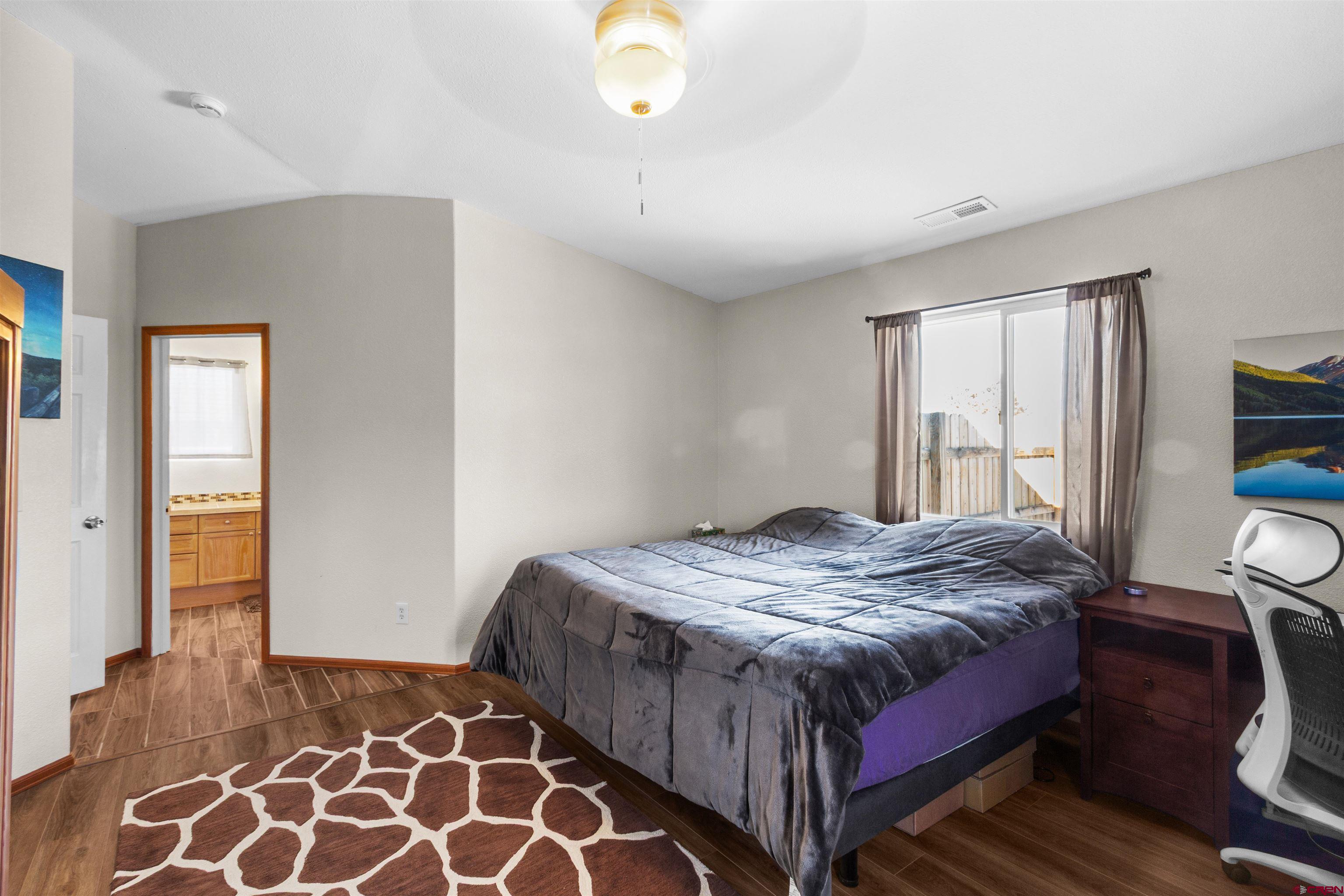 62920 Jeremy Road Montrose, CO 81401 - Photo 13 of 31 a bedroom with bed and a window