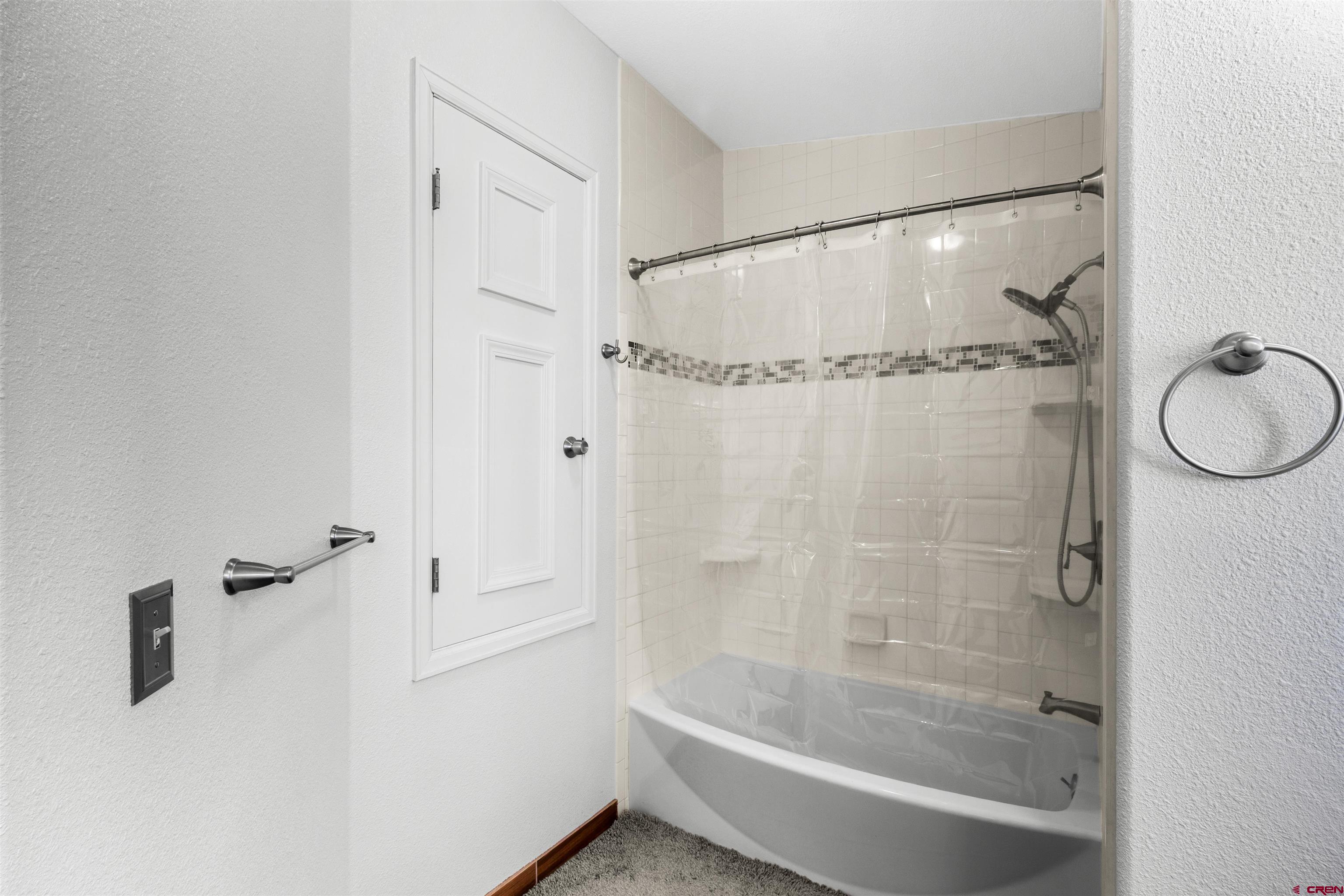 62920 Jeremy Road Montrose, CO 81401 - Photo 15 of 31 a bathroom with a glass shower door