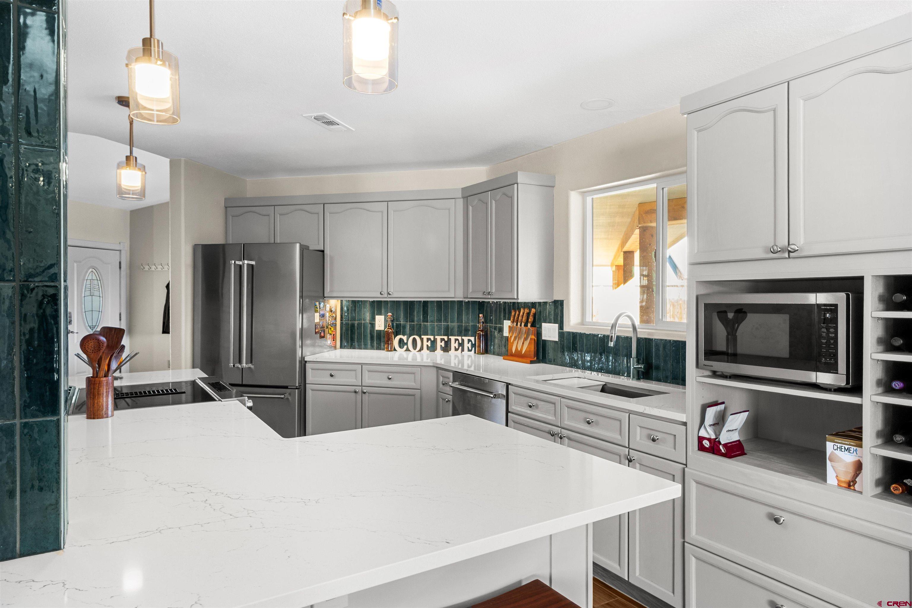 62920 Jeremy Road Montrose, CO 81401 - Photo 6 of 31 a kitchen with granite countertop a sink appliances and cabinets