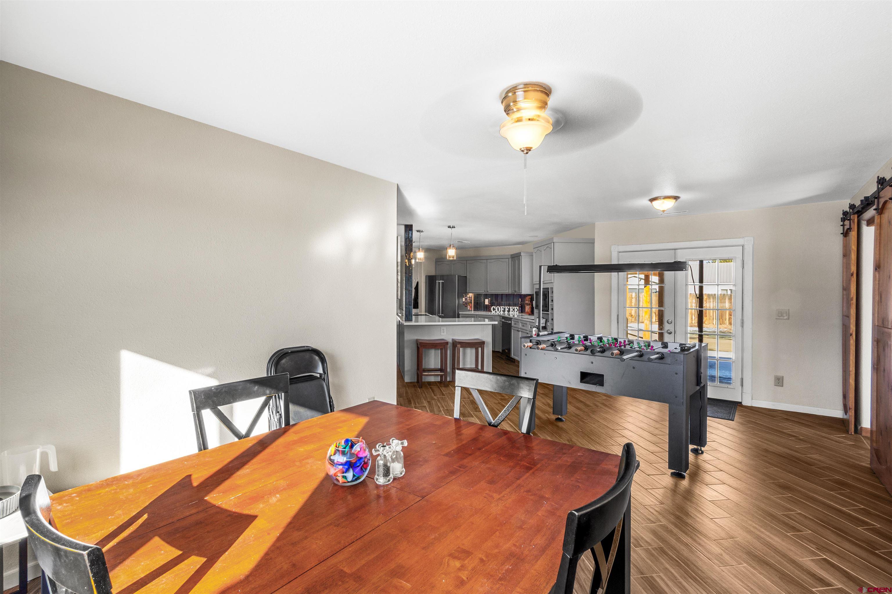 62920 Jeremy Road Montrose, CO 81401 - Photo 8 of 31 a dining room with furniture and wooden floor