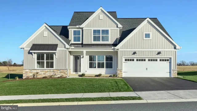 a view of a yard in front view of a house