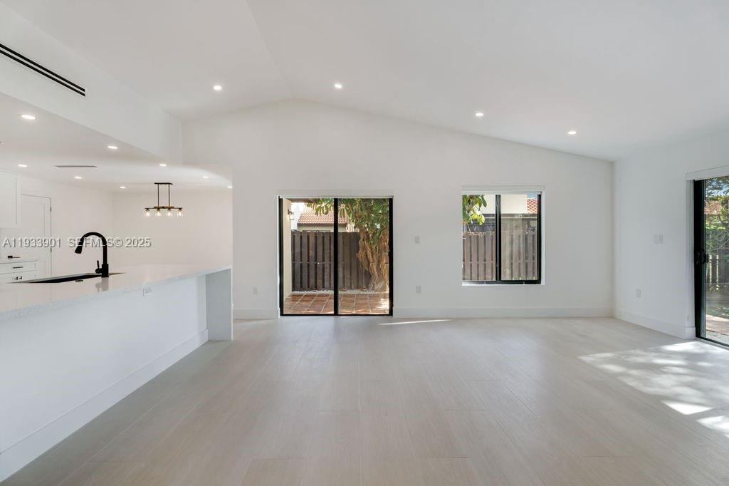 11256 Southwest 90th Lane, Unit 11256 Miami, FL 33176 - Photo 11 of 36 a view of an empty room with glass door