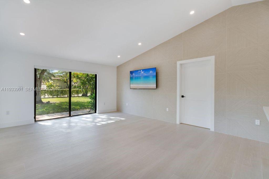 11256 Southwest 90th Lane, Unit 11256 Miami, FL 33176 - Photo 12 of 36 a view of an empty room with a sliding door