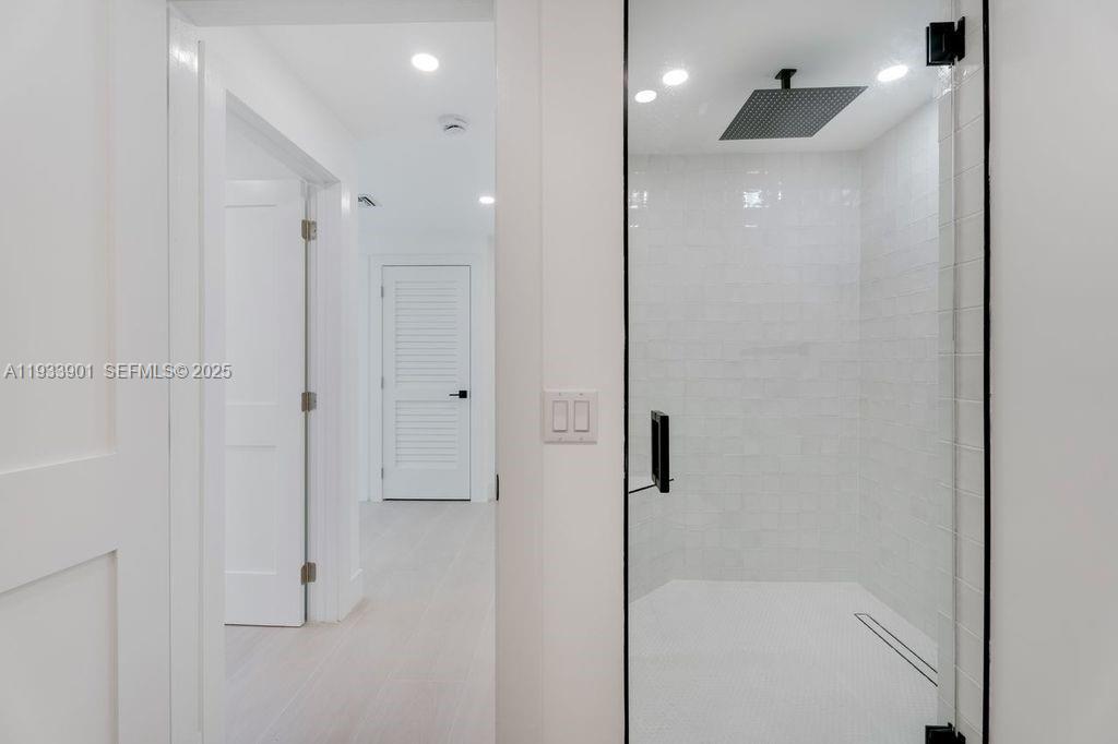 11256 Southwest 90th Lane, Unit 11256 Miami, FL 33176 - Photo 17 of 36 a bathroom with a shower and a glass door