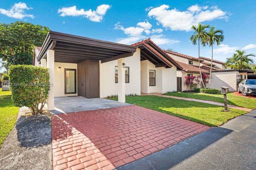 11256 Southwest 90th Lane, Unit 11256 Miami, FL 33176 - Photo 25 of 36 a front view of a house with a yard and garage