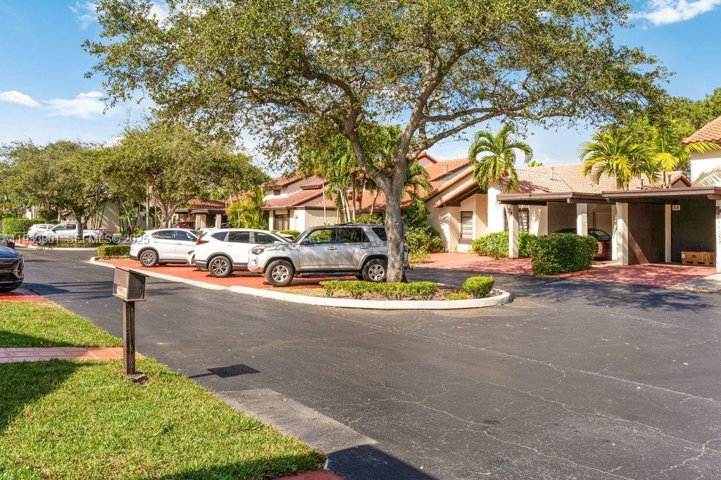 11256 Southwest 90th Lane, Unit 11256 Miami, FL 33176 - Photo 27 of 36 a front view of a house with garden