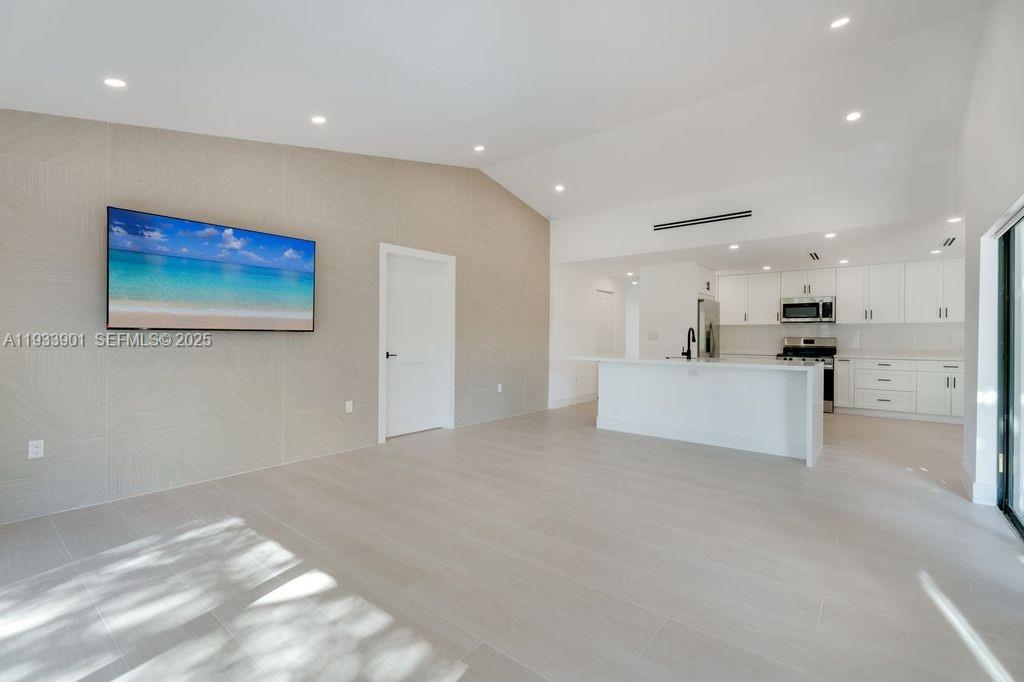 11256 Southwest 90th Lane, Unit 11256 Miami, FL 33176 - Photo 10 of 36 a view of kitchen with kitchen island white cabinets and refrigerator