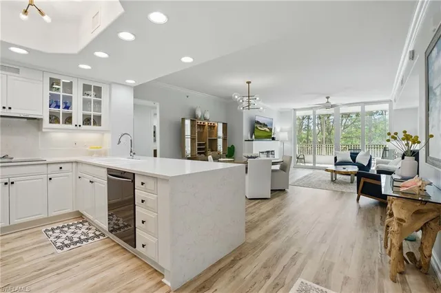 a kitchen with sink cabinets and wooden floor