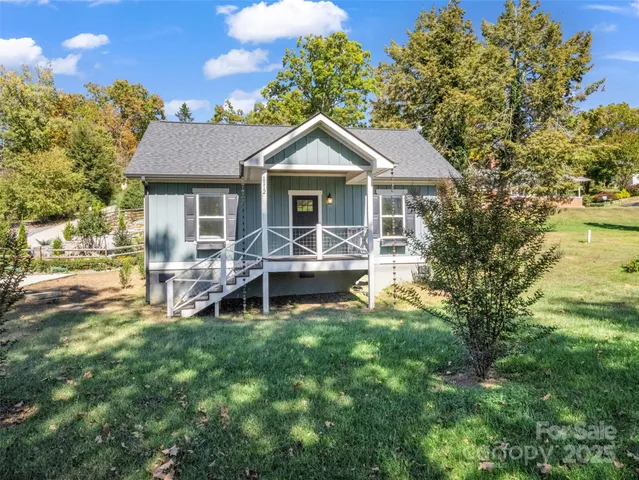 a view of a house with a yard and sitting area