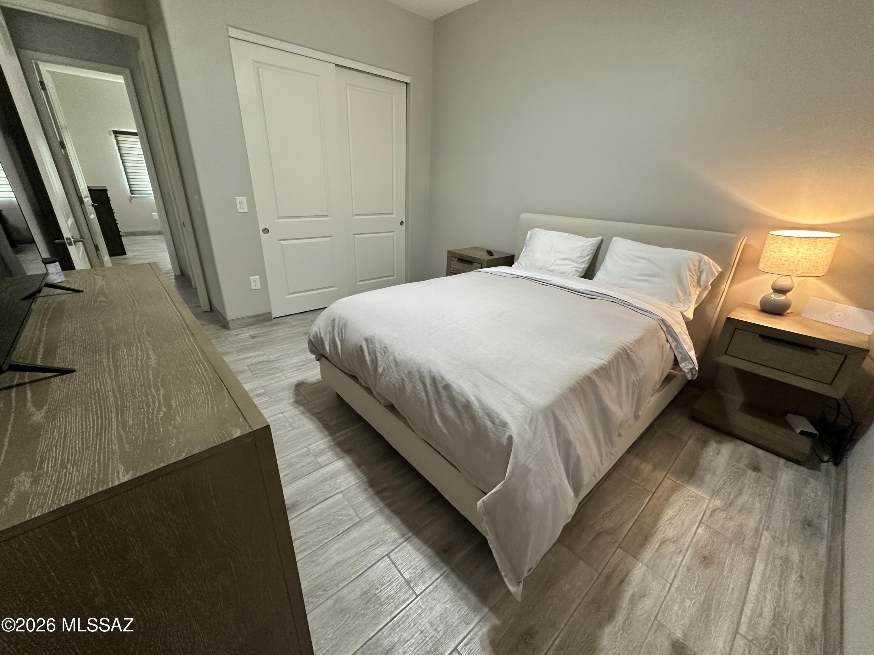 117 Ver Patria Rio Rico, AZ 85648 - Photo 9 of 28 a bedroom with a bed and wooden floor