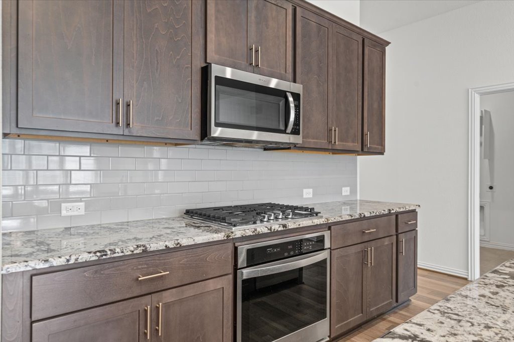 277 Spinnaker Loop Kyle, TX 78640 - Photo 12 of 38 A well-appointed culinary space featuring sleek stainless steel appliances and ample cabinetry.